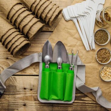 top-view-peat-pots-garden-tools-glass-jars-with-seeds-wooden-backgroundgrowing-seedlings_1048944-24456078