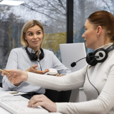 two-women-having-conversation-work-call-center-office